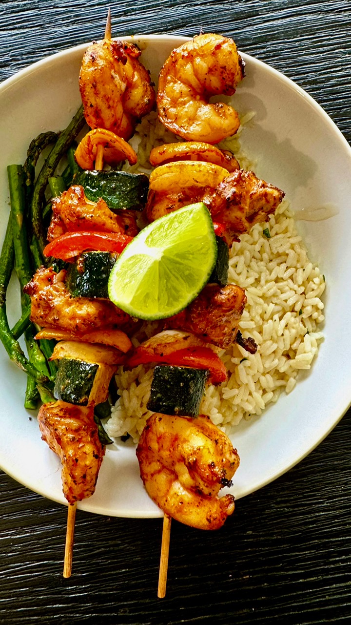 Grilled shrimp and chicken skewers with herbed rice and asparagus