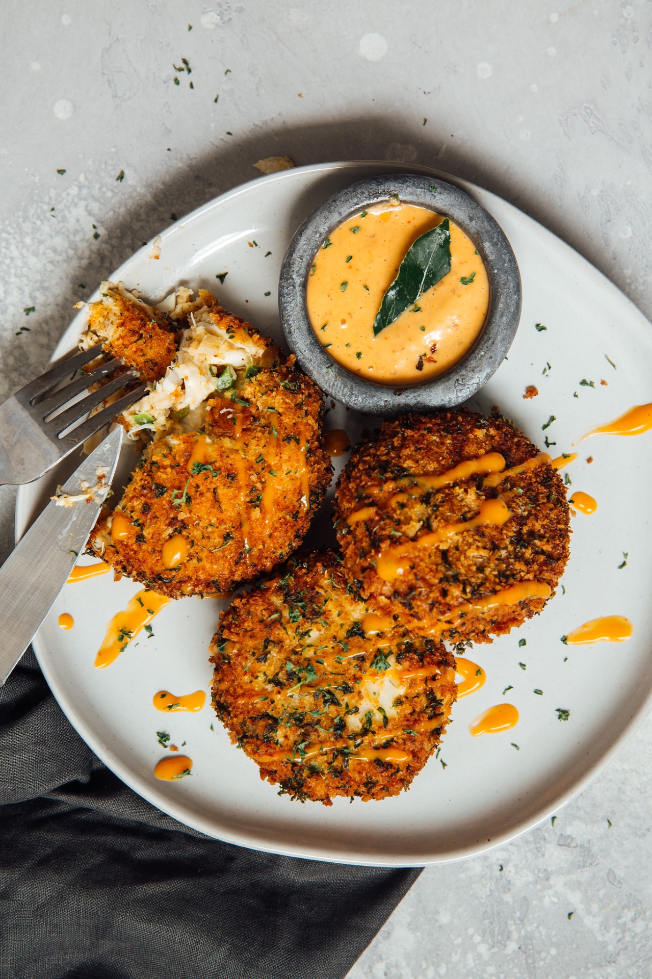 Golden crab cakes with house remoulade and fresh herbs