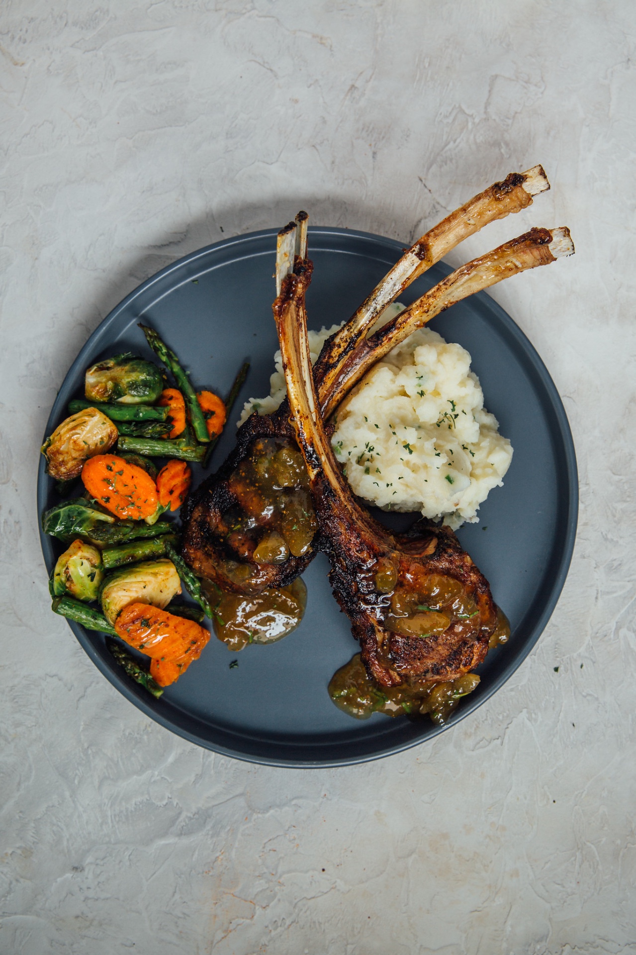 Glazed rack of lamb with whipped potatoes and roasted seasonal vegetables